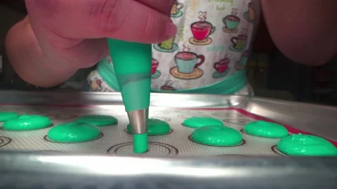 Piping macarons onto a tray to be baked Stock Footage 168465701
