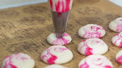 Piping Pink and White Marbled Macaron Batter onto Silicone Baking Sheet, Close U Stock Footage 343019545