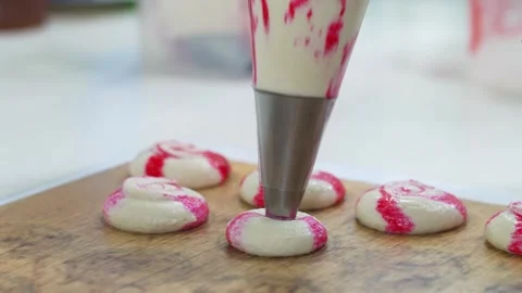 Piping Striped Macaron Batter onto Baking Sheet Stock Footage 343019515