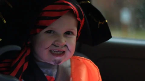 Pirate in car going tricker treating on halloween Stock Footage 32287395