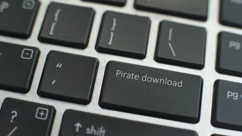 Pirate download button on computer keyboard, female hand fingers press key Stock Footage 97826163