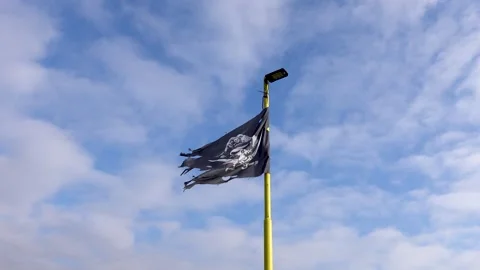 A pirate flag on a flagpole blows in the wind Stock Footage 262468077