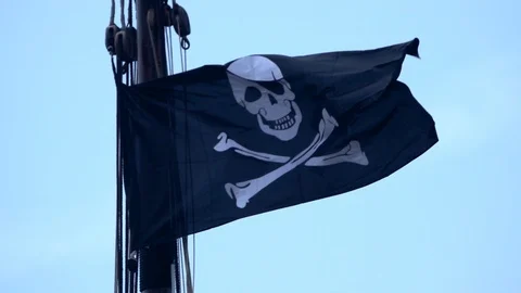Pirate flag is flying over a ship in front of blue sky Stock-Footage 90074620