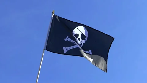 The Pirate flag waving in the wind in the blue sky Stock Footage 282432908
