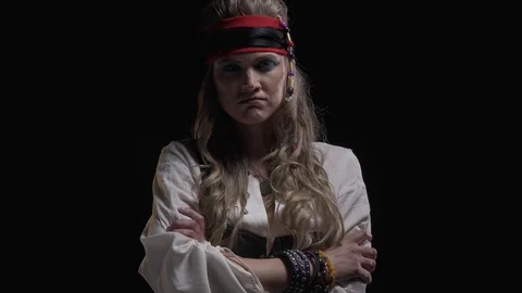 Pirate lady in old clothes is standing with serious expression on her face, 4k Stock Footage 109600337