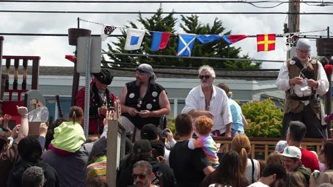 Pirate performers on parade float interact with crowd at outdoor festival Stock Footage 339036512