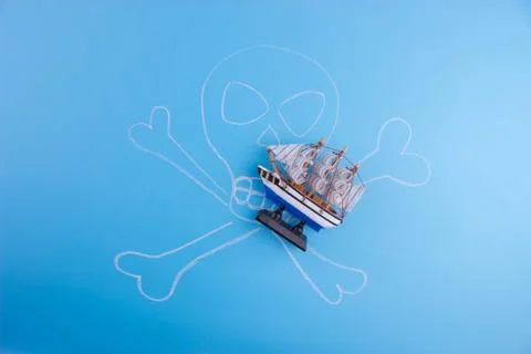 Pirate ship on blue background Stock Photos