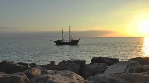 Pirate ship on open sea sunset Stock Footage 35461871