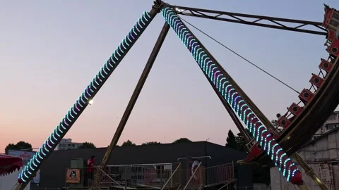 Pirate ship pendulum ride swinging at sunset amusement park Stock Footage 340281128
