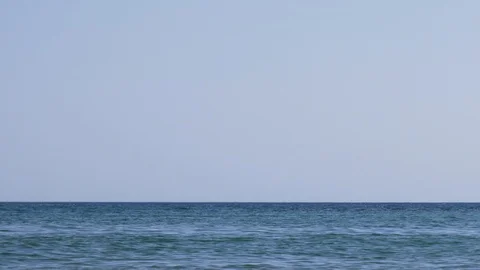 Pirate ship sails into view on blue ocean Stock Footage 98487145
