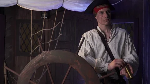 A pirate is standing on the ship and looking on the horizon with a spyglass, 4k Stock Footage 105404114