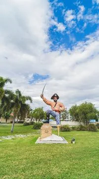 Pirate Statue standing on treasure chest with sword raised to the sky Stock Photos