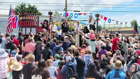Pirate themed parade float with performers and crowd in Washington state Stock Footage 339118991