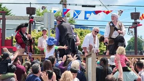 Pirate themed street parade float with costumed performers and crowd Video stock 339118977