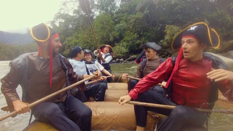 Pirates doing high five with their paddles after a long journey on a river in Stock Footage 119801659