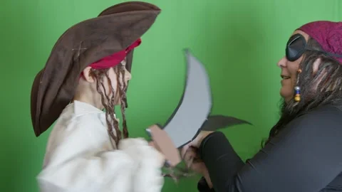 Pirates getting angry and fighting with cutlasses. Isolated on green background Stock Footage 265703131