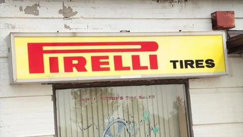 Pirelli tires horizontal rectangle sign logo above window on storefront building Stock Footage 249102885