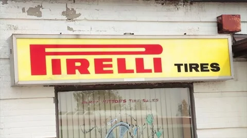 Pirelli tires horizontal rectangle sign logo above window with bus pulling up Stock Footage 249102902