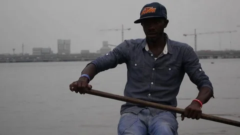 Pirogue driver on the Wouri,  Douala background Stock Footage 80969216