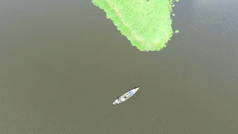 Pirogue passing by an island Stock Footage 87042219