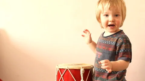 Pirtrait of two years old cute boy playing drum music young drummer hobby Vidéo 104984858
