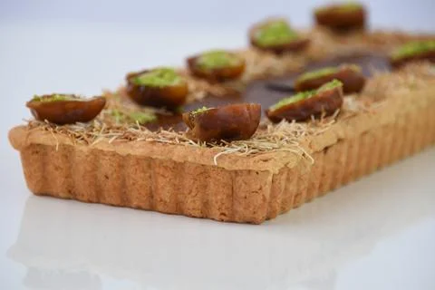 Pistachio and Date rectangular Tart garnished with halves of dates filled w.. Stock Photos