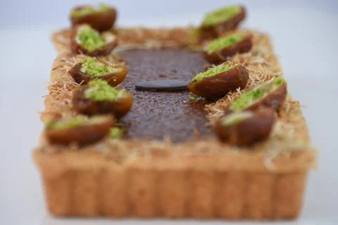 Pistachio and Date rectangular Tart garnished with halves of dates filled w.. Stock Photos