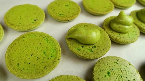 Pistachio Macarons halves with cream Stock Footage 62426508