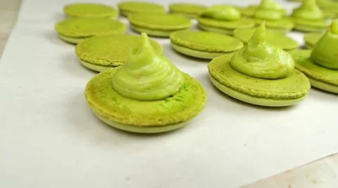 Pistachio Macaroons halves with cream Stock Footage 62426433