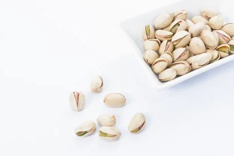 Pistachio nuts on dish Stock Photos