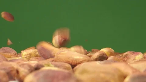 Pistachio Nuts Falling in Macro Extreme Slow Motion Green Box Video stock 126705182
