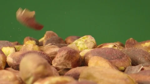 Pistachio Nuts Falling in Macro Extreme Slow Motion Green Box Stock Footage 126705585