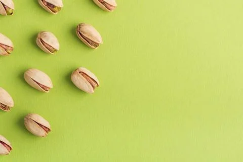 Pistachio Nuts Pattern with Copy Space on Green Background Foto stock