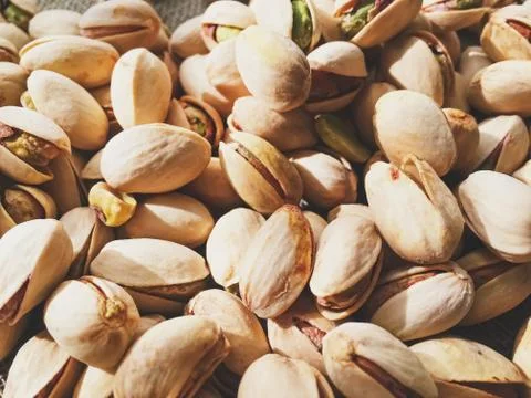 Pistachio nuts on rustic linen background Stock Photos