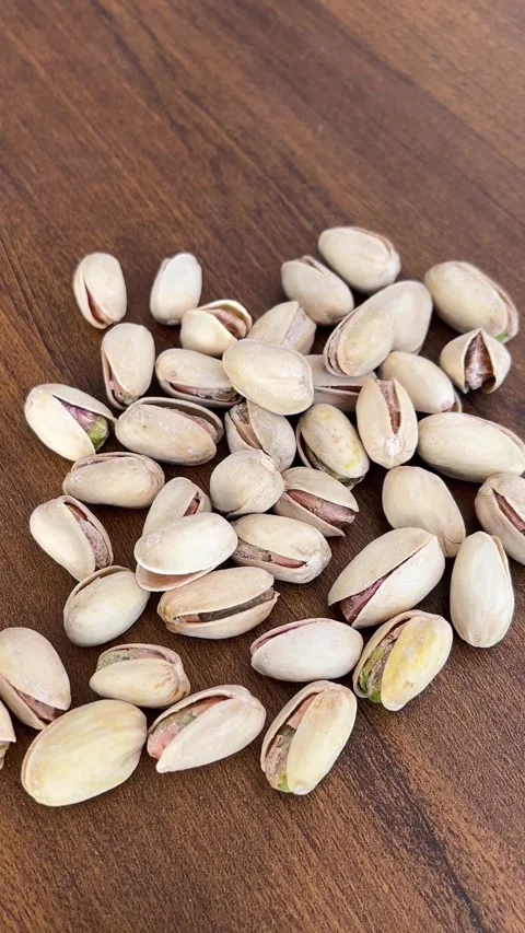 Pistachio Nuts on Table Surface - Healthy Snack Close-Up 動画素材 323271735