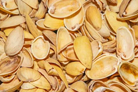 Pistachio shells. The background image of the surface texture close-up. Stock Photos