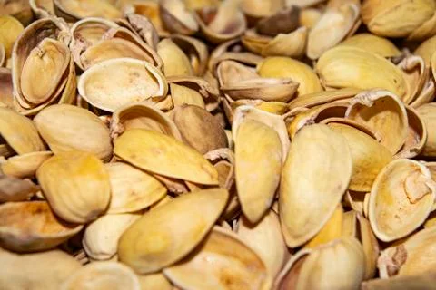 Pistachio shells. The background image of the surface texture close-up. Stock Photos