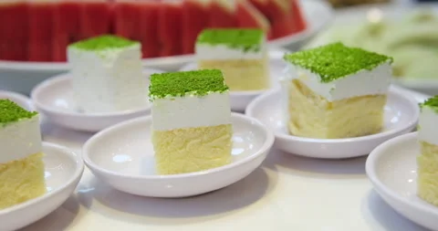 Pistachio sponge cake at the buffet table sprinkled with green freeze-dried Stock Footage 276574110