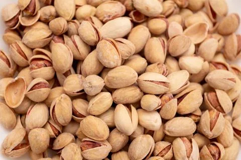 Pistachios background and nuts texture. Stock Photos