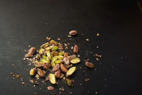Pistachios on black slate table Stock Photos