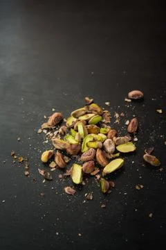 Pistachios on black slate table Stock Photos