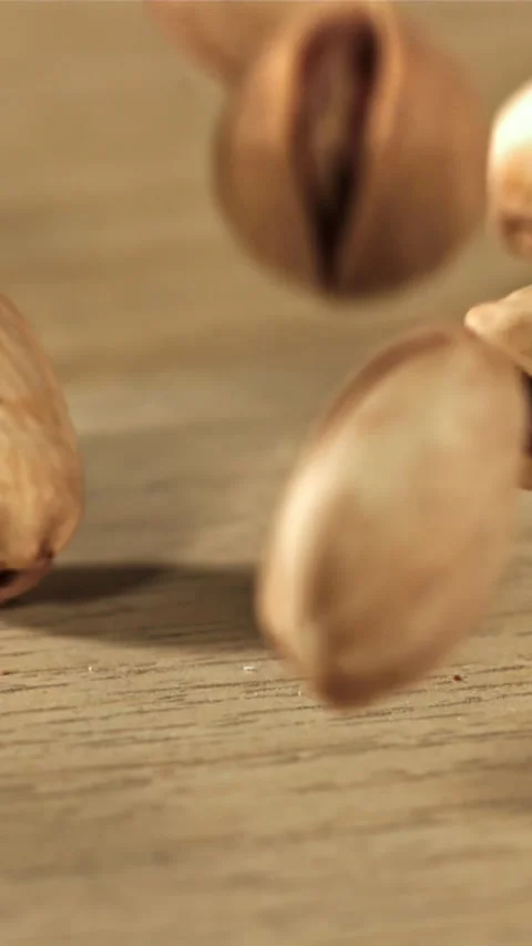 The pistachios fall on the table. Filmed on a high-speed camera at 1000 fps Stock Footage 335304226