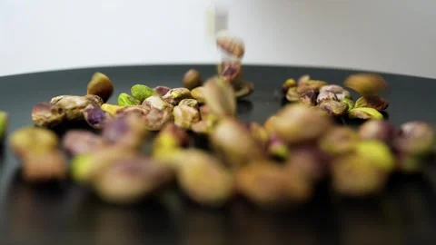 Pistachios Falling on Black Surface, Close-up of pistachios falling on a bl.. Stock Footage 320727475