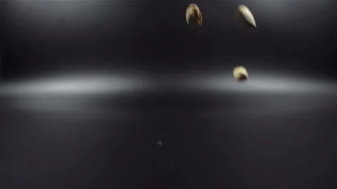 Pistachios falling in slow motion on black background Stock Footage 104576466