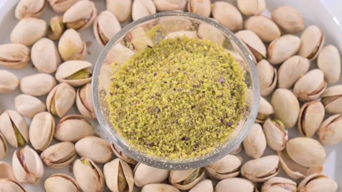 Pistachios. Nuts pistachios with shells and ground in a cup. Close-up. Food with Video stock 204748081
