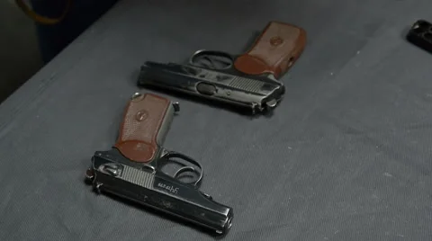 Pistol and bullets on the table Видео 62447487