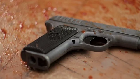 Pistol in blood close-up Video stock 71542345