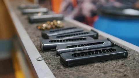 Pistol clips with bullets in shooting gallery Stock Footage 82126844