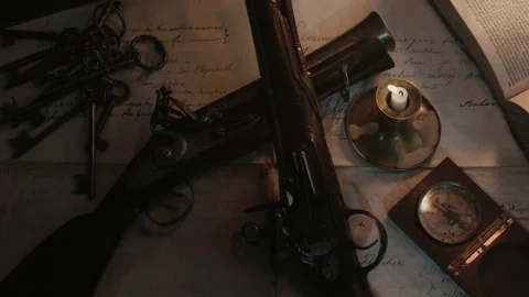 Pistol Compass and Candlelight on the table of the captain Stock Footage 259622730