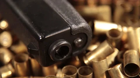 Pistol Glock 17 on Shells, Macro Dolly Detail Graphic Background Stock Footage 55317424